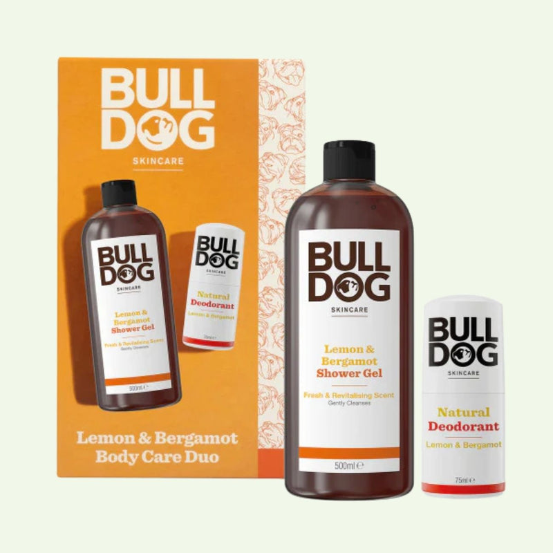 The Lemon & Bergamot Body Care Duo is displayed in front of bold orange and yellow packaging—ideal for men who enjoy fresh, invigorating body care products.